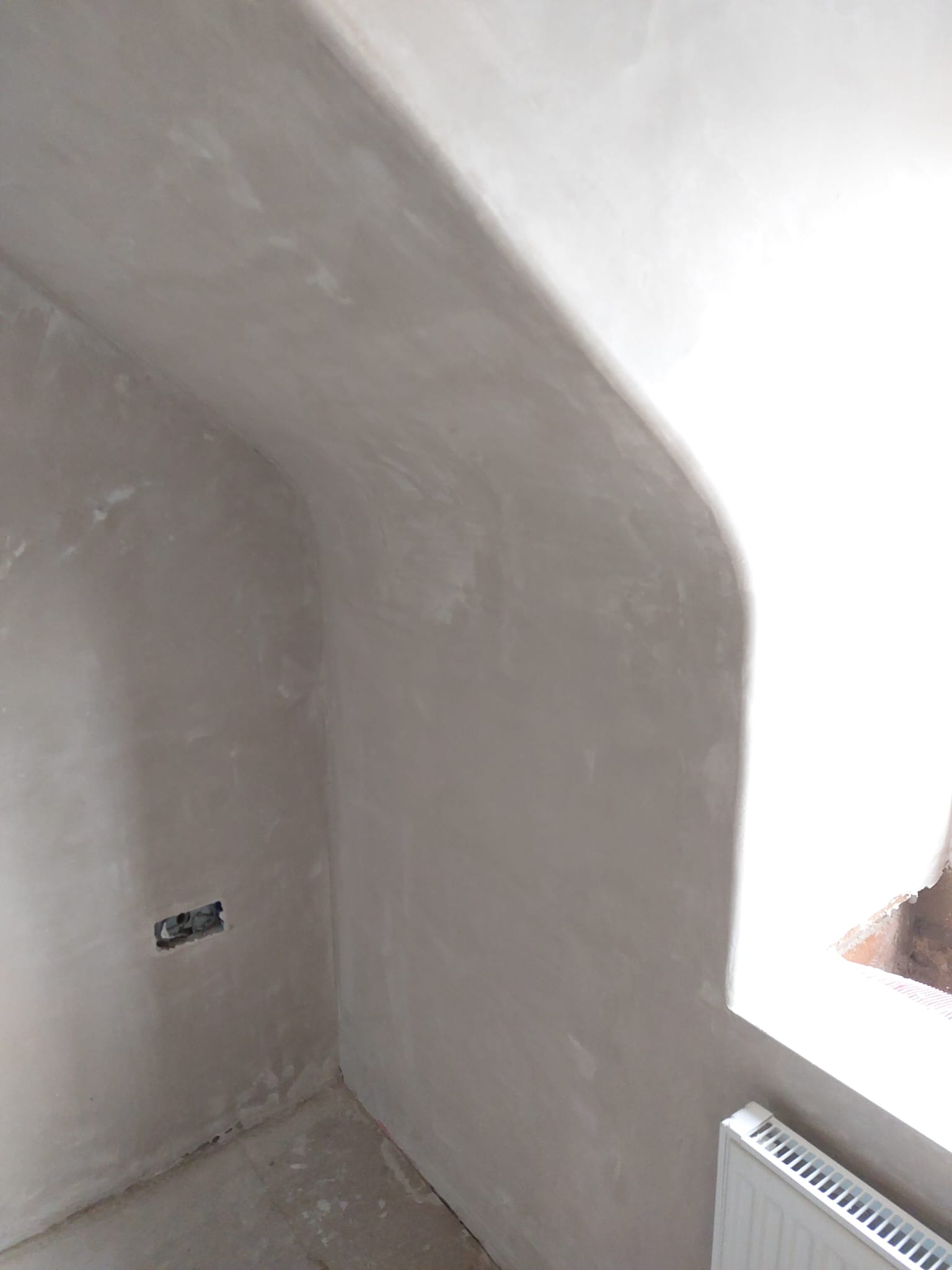 Sloped wall finished into a rounded return