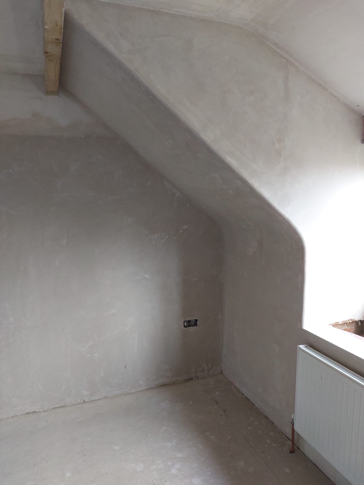 Plastered slope and wall beside a beam